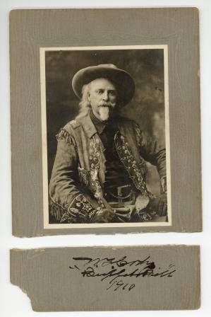 A mounted 22.3 x 14.7cm black and white half-length: A mounted 22.3 x 14.7cm black and white half-length photograph of legendary American frontiersman William Frederick Cody, better known as 'Buffalo Bill', signed and dated in black ink on mount below p
