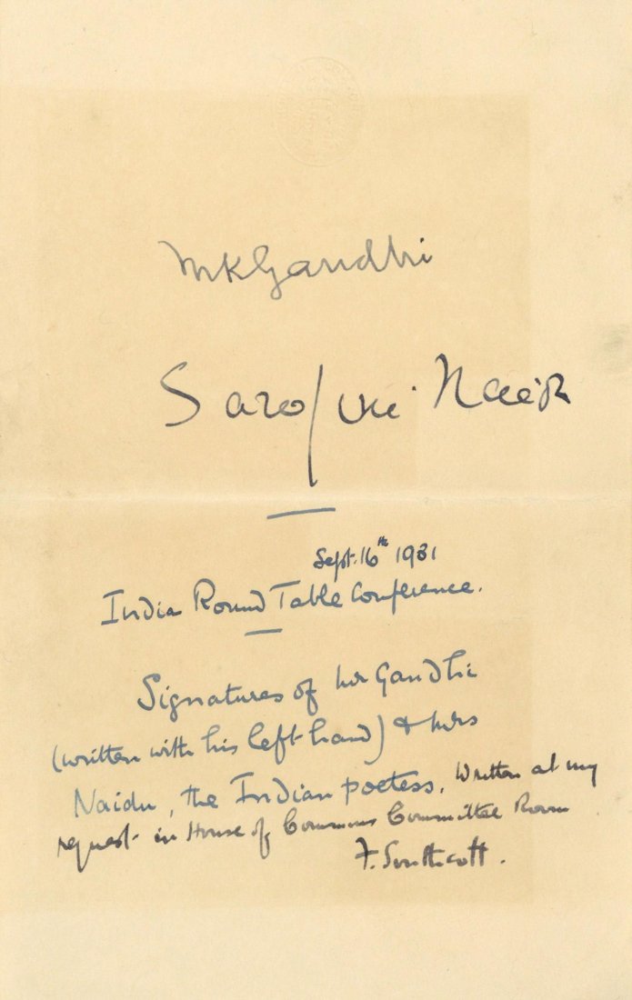 Blue ink signatures of Mahatma Gandhi and Sarojini: Blue ink signatures of Mahatma Gandhi (M.K. Gandhi) and Sarojini Naidu on 18.7 x 11.8cm paper with embossed letterhead of the House of Commons. A handwritten annotation in blue ink below the autograph
