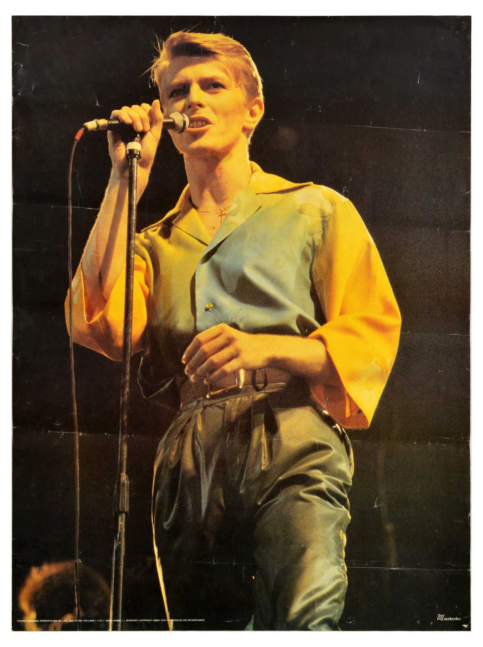 Advertising Poster David Bowie Singing Music Concert: Original vintage music advertising poster for David Bowie published by Verkerke Reprodukties - Photograph features Bowie singing on a black background Good condition, creasing, pinholes, folds. Countr