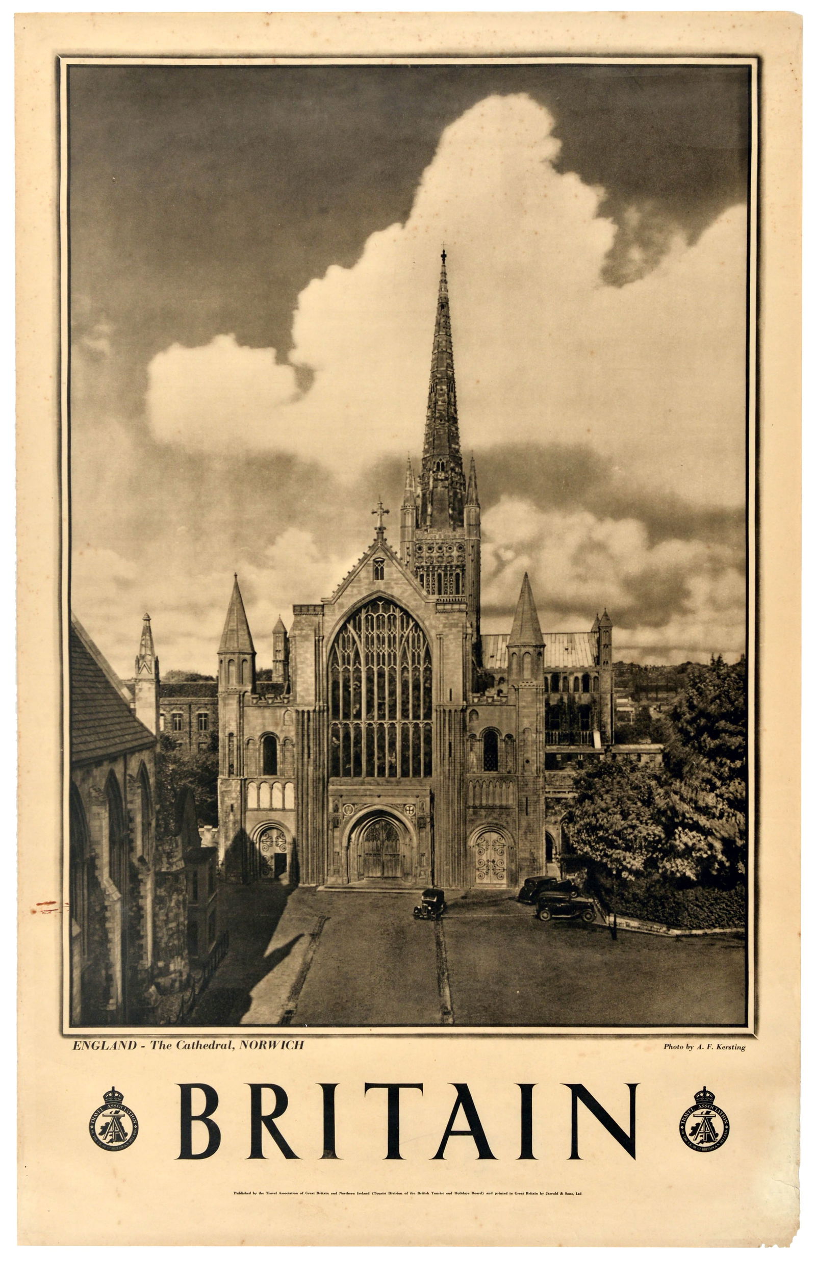 Travel Poster Britain Norwich Cathedral: Original vintage travel poster for Britain and England featuring a black and white photo Norwich Cathedral set against a cloudy sky with classic cars parked by the entrance. Photo by A.F. Kersting. Bo