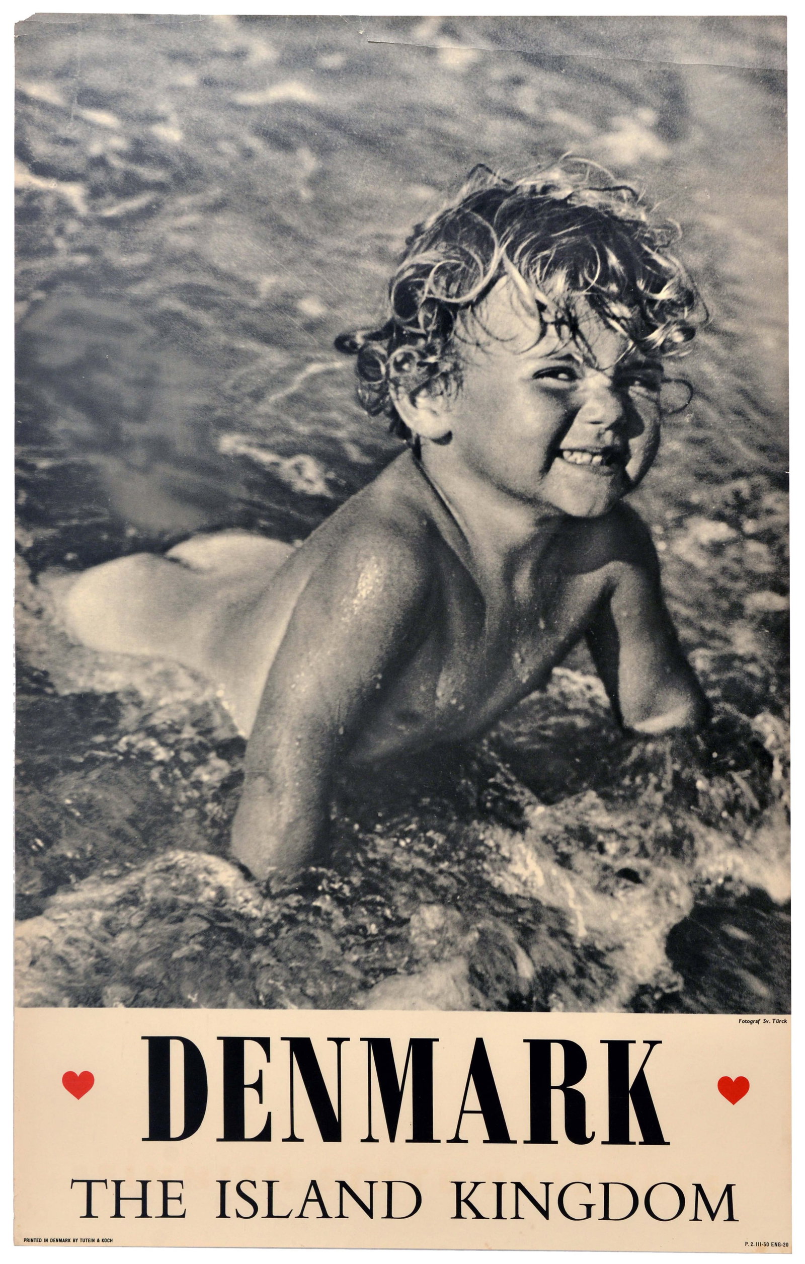 Travel Poster Denmark Island Kingdom Beach Sea: Original vintage travel poster - Denmark The Island Kingdom, featuring a black-and-white photograph of a smiling child playing in the breaking surf along a Danish beach, with two red hearts flanking t