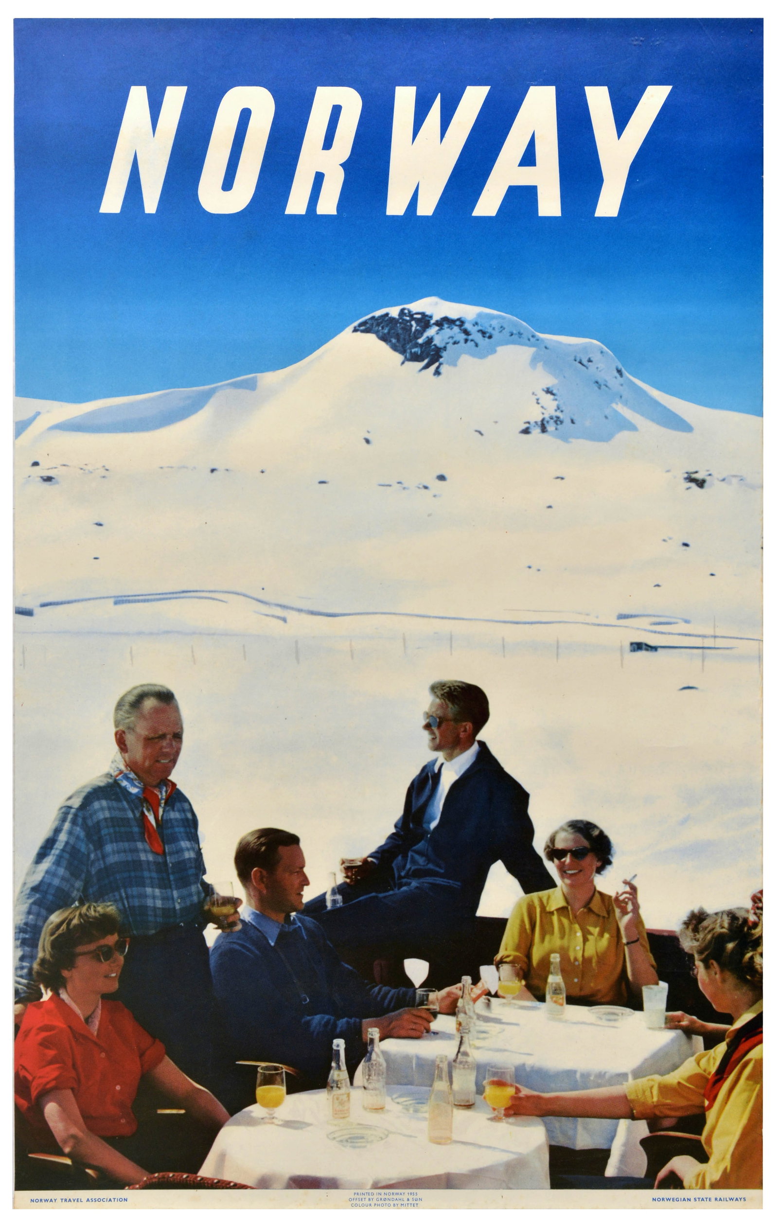 Travel Poster Norway Winter Sport Norwegian State Railways: Original travel advertising poster for Norway, featuring a photograph of a group of people sitting around a table with drinks and refreshments on a patio in the foreground, a snow-covered mountain pea