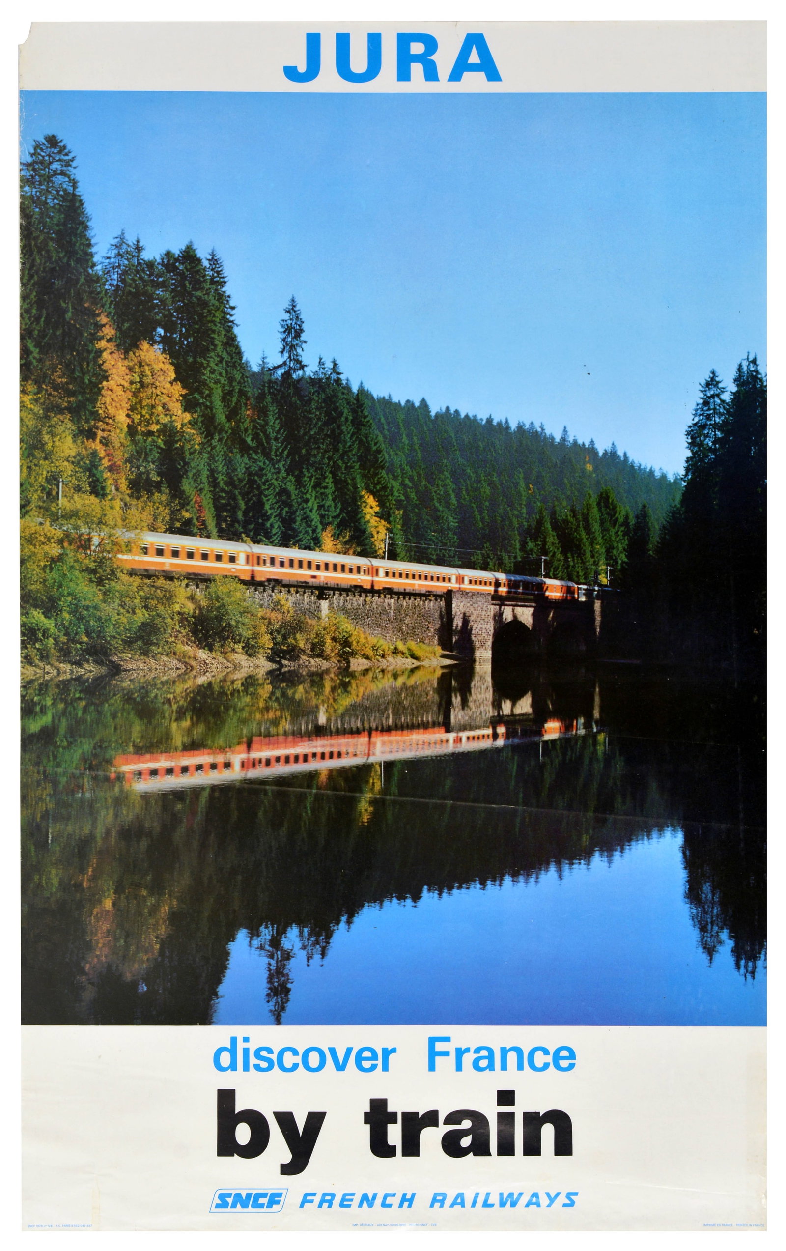 Travel Poster Jura France French Railways SNCF Train: Original vintage advertising poster for Jura, published by French Railways SNCF, featuring a serene photographic scene of an orange and grey SNCF train crossing a bridge, mirrored in the glassy, still