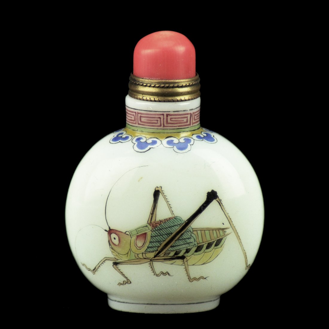 A Chinese peking glass snuff bottle: A Chinese peking glass snuff bottle with insect figure, coral cap, marked. ht. 2 1/2 in.