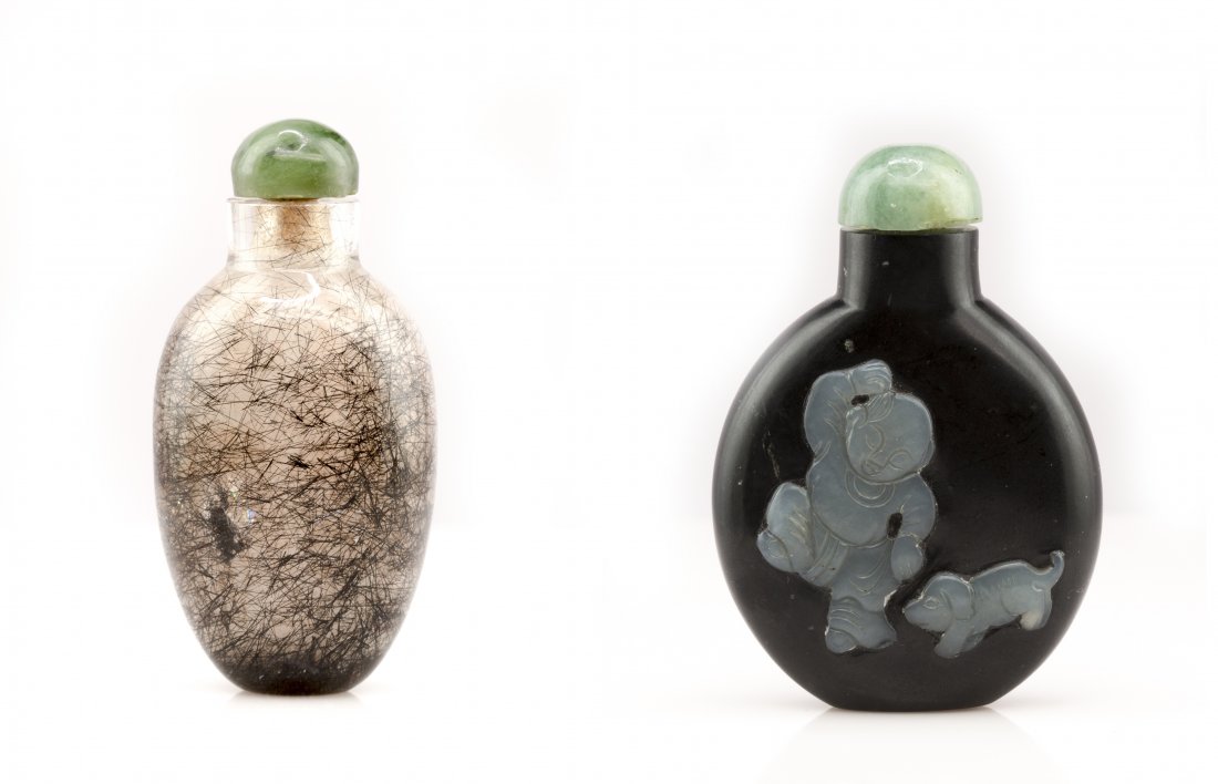 Two Chinese Snuff Bottles: First one is rock crystal and boy playing inlaid on stone of the second. Respectively ht. 2 1/2 in., 3 in.