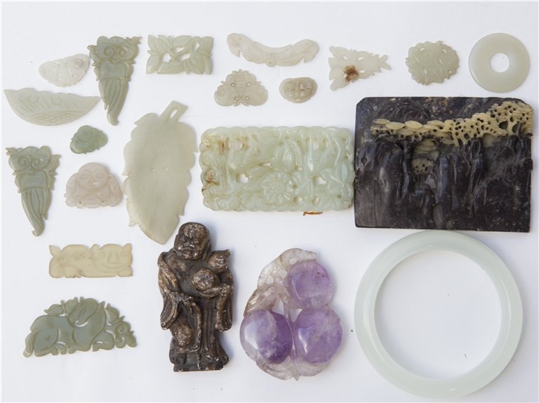 SEVENTEEN PIECES OF CHINESE JADE AND SOAPSTONE CARVINGS: Seventeen Chinese Jade and Soapstone Carvings, One (1) Bangle, Two (2) plaques, One (1) buddha figure and Two (2) pendants, and many small carving.