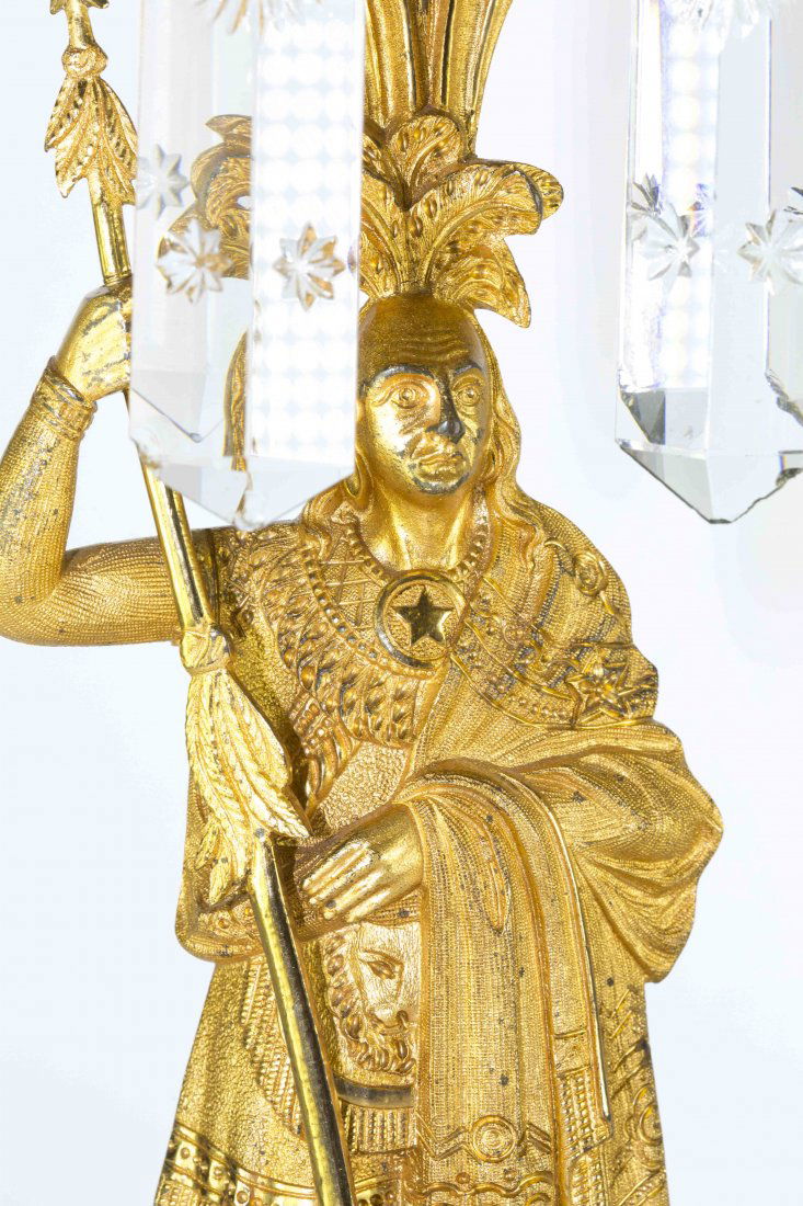 PAIR VICTORIAN GILT BRONZE GIRANDOLE CANDLEHOLDERS: Pair of Victorian Gilt Bronze Girandole Candleholders. Daniel Boone Pattern. Two Piece Gilt Bronze Girandole Garniture Set with snowflake prisms. Depicting figures from James Fenimore Cooper's Leather