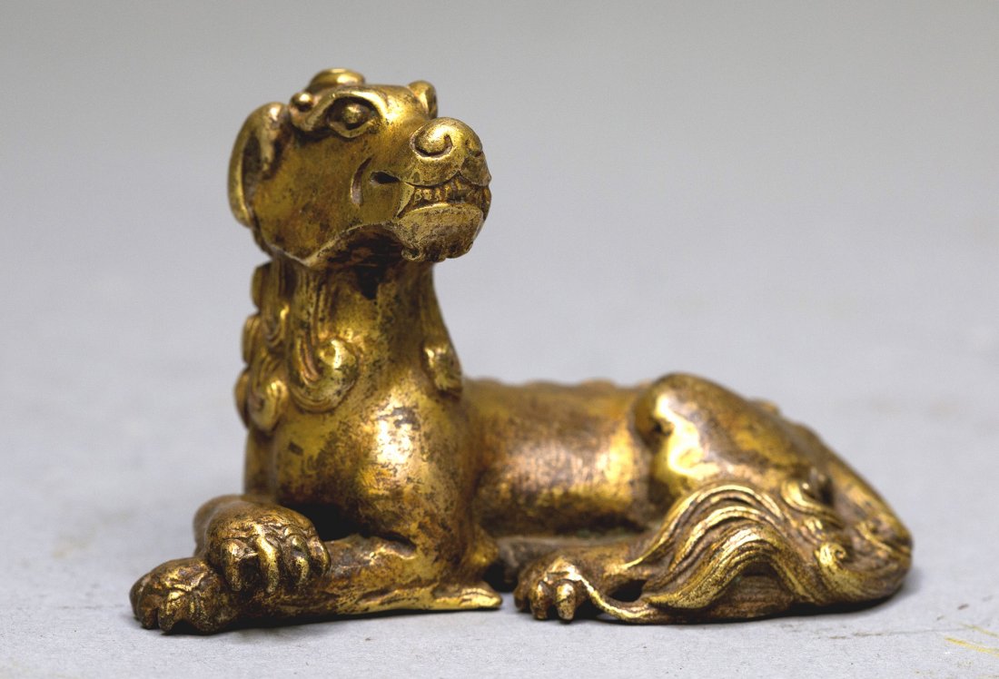 A SMALL GILT-BRONZE MYTHICAL BEAST (1 of 5)
