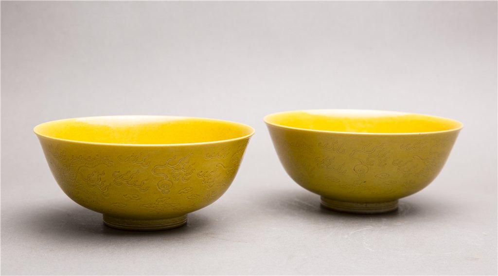 A PAIR OF YELLOW GLAZED BOWLS WITH INCISED DECORATIONS: A Pair Of Yellow Glazed Bowls With Incised Decorations Of Dragons diam. 5 3/4, ht. 2 1/2 in.