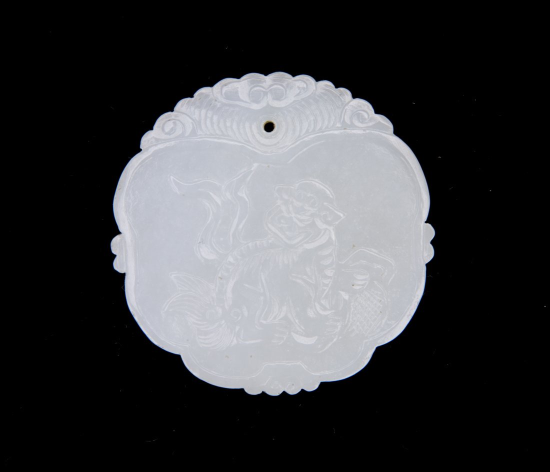 A CARVED JADE CIRCULAR PLAQUE: A Carved Jade Circular Plaque Diam. 1 7/8 In.