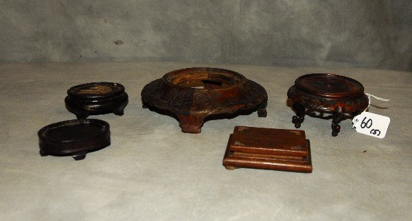 Five antique Chinese carved hardwood stands. Largest: (1 of 3)