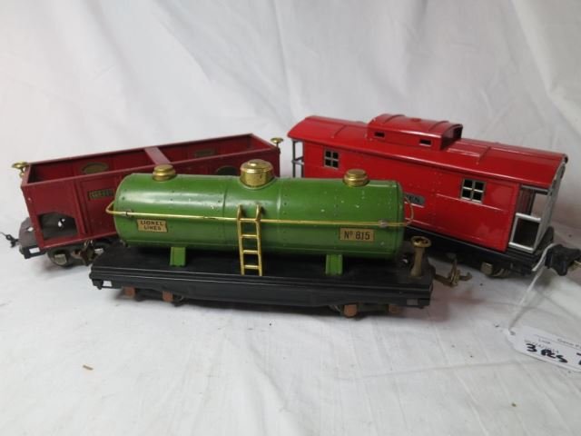 Three Prewar Tin Lionel Train Cars - 817 Caboose: Red, 816 Red Hopper, and 815 Green Tanker.