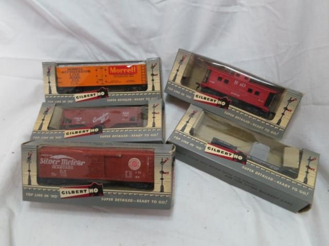 Five Gilbert HO Gauge Train Cars in Original: Boxes - 524 Morrell Refrigerator Car, 501 Everywhere West Hopper, 33519 B&O Caboose, 33514 Seaboard Box Car, 503 Depressed Center Car w/ Load.