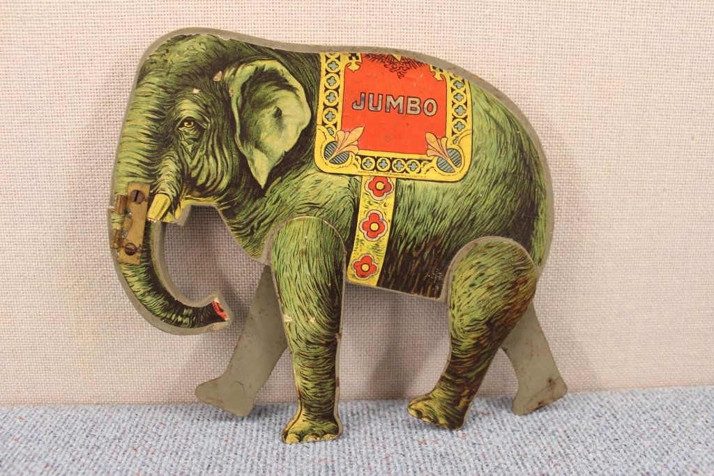 Gibbs 1911 Jumbo Play Elephant Litho Wood: Copyright 1911 The Gibbs MFG CO., Canton, OH. Wooden body with metal legs . His trunk has been shortened and reattached, see photo. 7 3/4 inches tall and he does stand on his own when posed.
