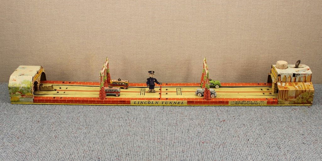Unique Art "Lincoln Tunnel" Tin Litho Wind Up Toy: Made by Unique Art MFG CO., New Jersey. Wind up clockwork does function. Six cars. 24 inches long.