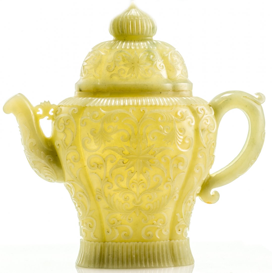 A VERY RARE CHINESE QING DYNASTY (16441911) JADE TEAPOT: A VERY RARE CHINESE QING DYNASTY (16441911) JADE TEAPOT CARVED IN THE MUGHAL STYLE the transparent whitegreenish jade, finely carved and polished, richly decorated in relief with carved chrysanthemums