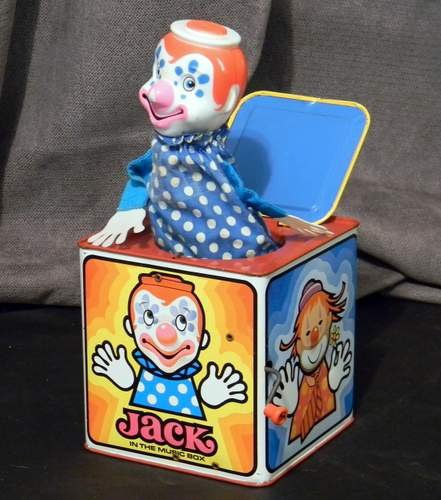 Vintage 1971 Mattel Jack in the Music Box Tin Toy: This retro toy plays Pop Goes The Weasel and pops on it’s mark. Clown eyes jiggle. It measures approximately 5.5" squared. Original box not included.