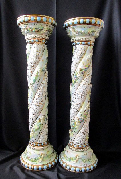 2 Large Capodimonte Pedastals: 2 Large Capodimonte pedestals to display your collectibles. These unique porcelain finely hand painted pedestals adorned with cherubs and flowers and touched with gold detail will add an elegant accen