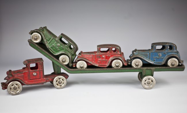 1920\'s CAST IRON AUSTIN CAR CARRIER / TRACTOR TRAILER: Very Rare and original, 1920\'s Cast Iron Austin Car Carrier Tractor Trailer Truck manufactured by A. C. Williams. This early, cast iron Automobile Transport Truck toy measures 12 1/4” long by 4 1/4