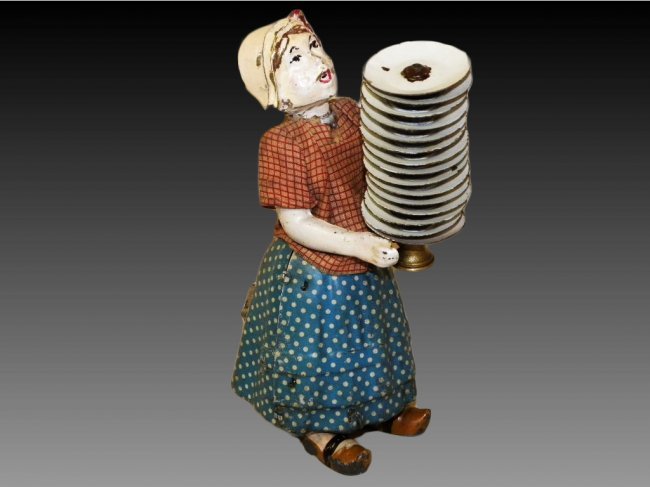 Rare Fernand Martin Madelon with Dishes: Fernand Martin, France, a very amusing and inventive toy design, features woman holding stack of plates while attempting to walk and not drop them all without apparent success. 6 1/2" h