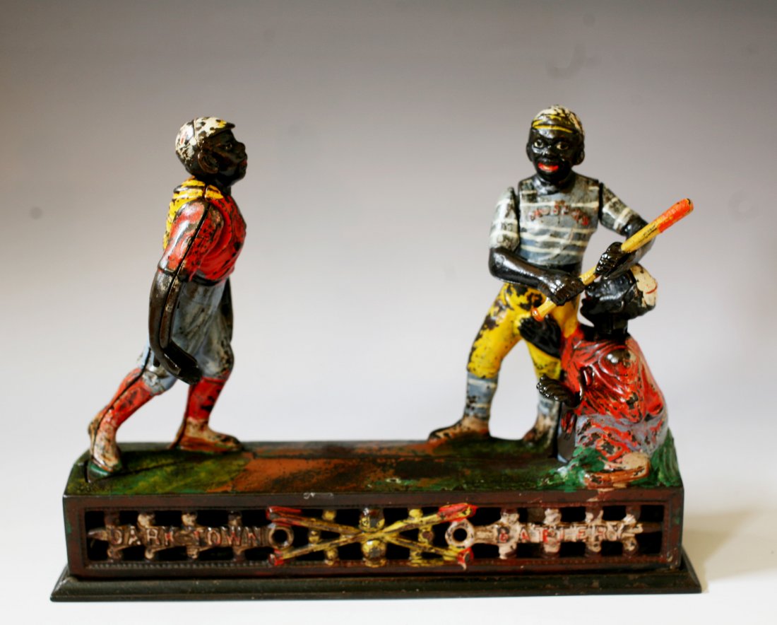 Darktown Battery " Mechanical Bank c 1888: original cast iron Darktown Battery Baseball mechanical bank made by J & E Stevens cir. 1888.. He pitches the coin and the batter swings, but the coin sails so quickly by him that it deflects off the