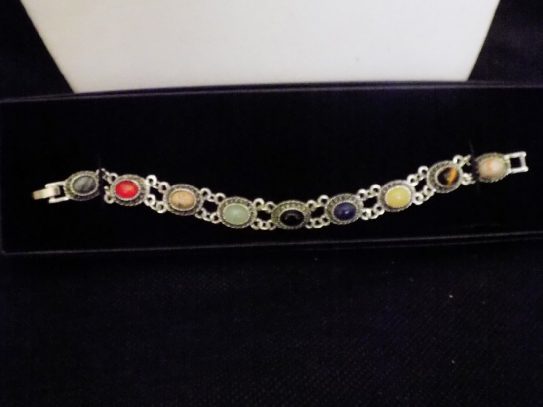 ANTIQUE STYLE BRACELET W /GENUINE GEMSTONES & SODALITE: This is an Antique style bracelet made of .75CT. of Sodalite. It is Silver-tone and features 9 different gemstones. The bracelet is 7.5in.L with a secure fold clasp. It features 9 1CT. Oval shaped gem