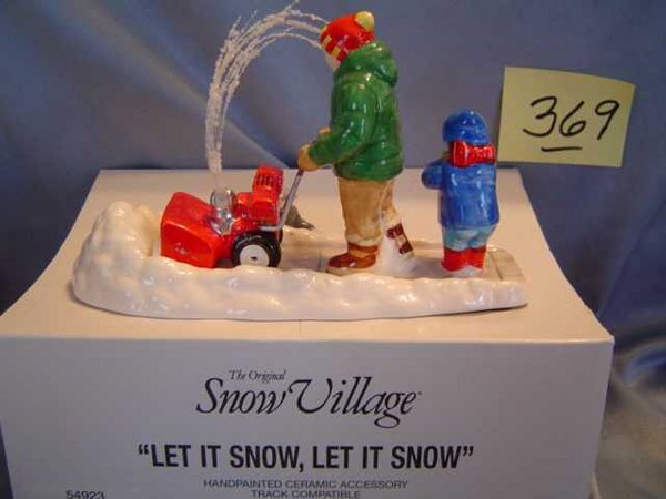 Dept 56 Snow Village "Let it Snow Let it Snow": Figure pushing a snow blower through a pile of snow while child follows behind and "snow" blows out top of blower. Comes in its own original box; mint condition. Green book # 5492-3. Retired in 2000.