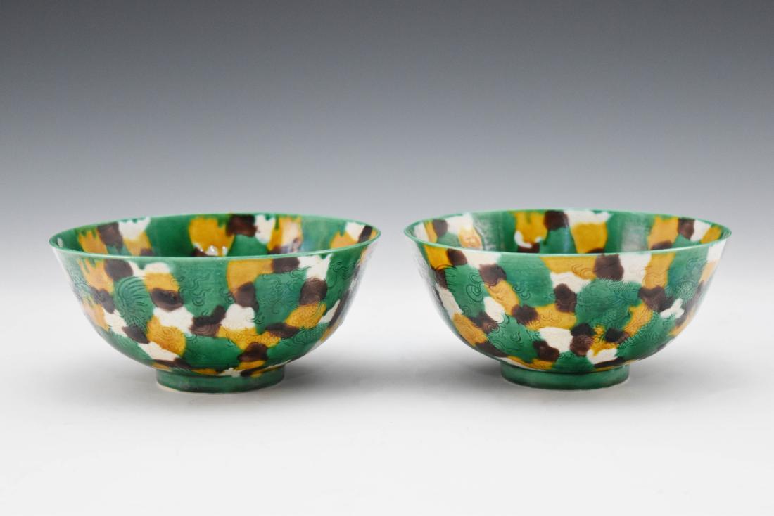 PAIR OF SANCAI SGRAFITTO BOWL: Finely potted Chinese porcelain in a deep vessel, with rounded cavetto rising a steep sides toward slightly flared rim, upon a ring footed base. The exterior decorated with hand painting in SanCai des