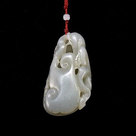 FU-BAT AND LINGZHI MUSHROOM JADE PENDANT: The Chinese nephrite jade carved unto a Fu-Bat over LingZhi sacred fungus. The jade shows grayish crème iridescent with moist milky appearance. Dimension: 76.47mm H x 41.51mm W Weight: 115.30 grams