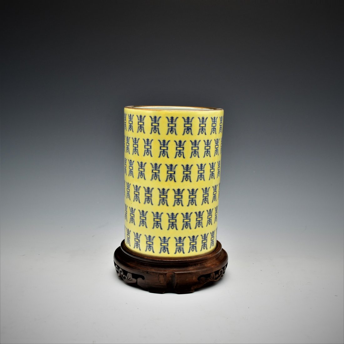 HUNDRED SHOU PORCELAIN BRUSH POT: Having slightly waisted cylindrical body, wide opening with flat base. The exterior hand painted in cobalt blue calligraphy of hundreds longevity "Shou" characters. Unglazed underbase revealed pale-cr
