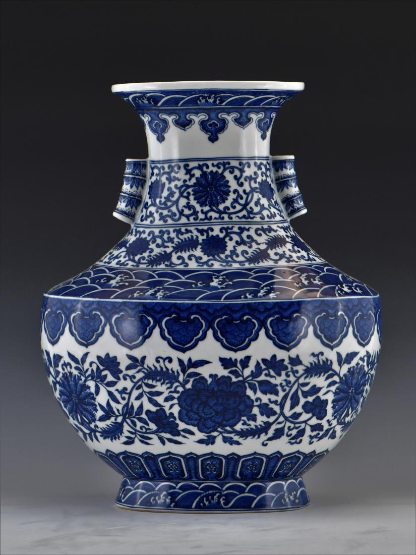 FINE BLUE AND WHITE LOTUS VASE: FINE Chinese Blue and White Vase. Bulbous body, waisted neck with slightly flared rim, squared to shoulder. Delicately hand painted in blue and white style , double banded with various repeating ruyi 