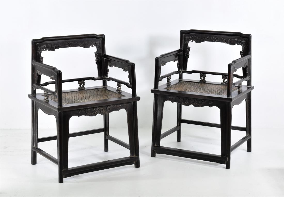 19TH PAIR OF CARVED ZITAN ROSE CHAIRS, MEIGUI YI: Each with an open-carved back frame formed by a straight top rail rounding the corners to the back posts, set with an inset beaded border apron and spandrels, the straight arms continuing down to form