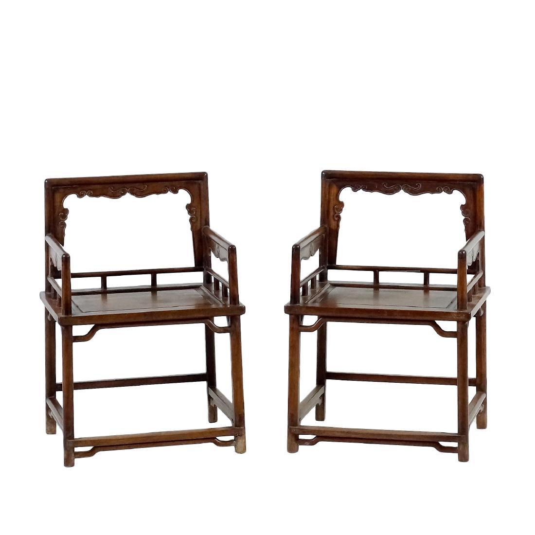 PAIR OF CARVED HUANGHUALI ROSE CHAIRS, MEIGUI YI: Each with an open-carved back frame formed by a straight top rail rounding the corners to the back posts, set with an inset beaded border apron and spandrels finely carved with archaistic T-scrolls, t
