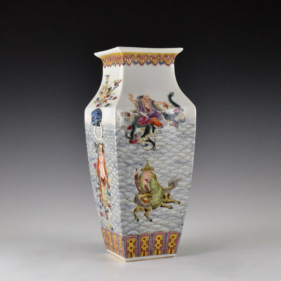 FINE FAMILLE ROSE EIGHT IMMORTALS VASE: Chinese famille rose Eight Immortals porcelain vase. Stoutly potted of squared baluster body, with cornered shoulder gently waisted toward flaring rim and square opening , raised on countersunk flat b