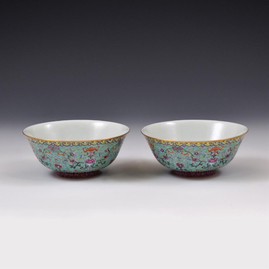 PAIR OF TURQUOISE SGRAFFITO-GROUND BOWLS: Pair of Chinese YongZheng famille rose porcelain bowls. The exterior magnificently detailed with famille rose colorful rococo floral blossoms amidst leafy tendrils, bordered by repeated Ruyi pendant p