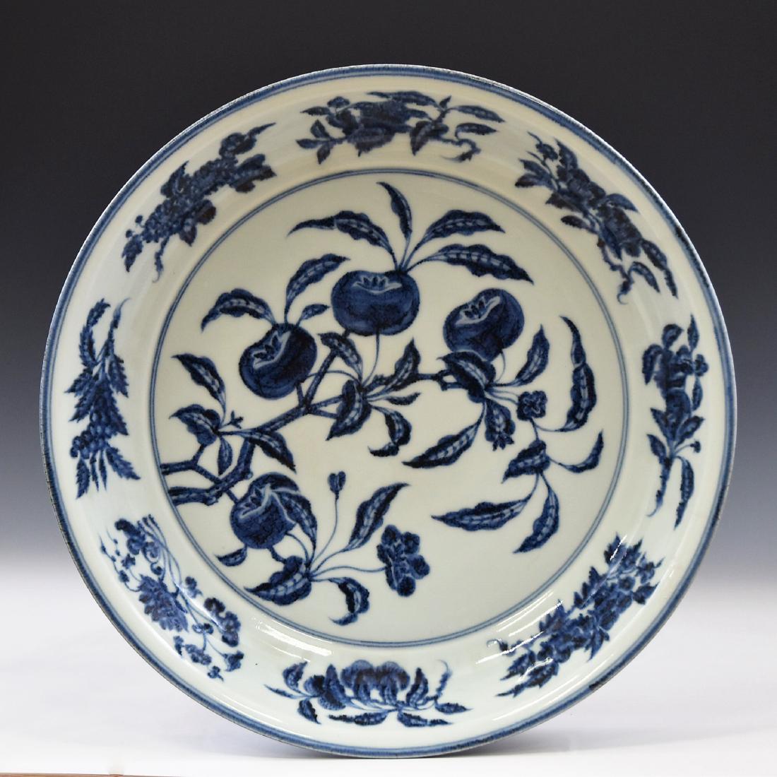 LARGE BLUE & WHITE PERSIMMONS ABUNDANT CHARGER: A large Chinese Ming Dynasty porcelain charger, center body decorated in cobalt-blue glazed persimmons abundant and foliate enclosed within double fine blue rings compromising the cavetto, before band