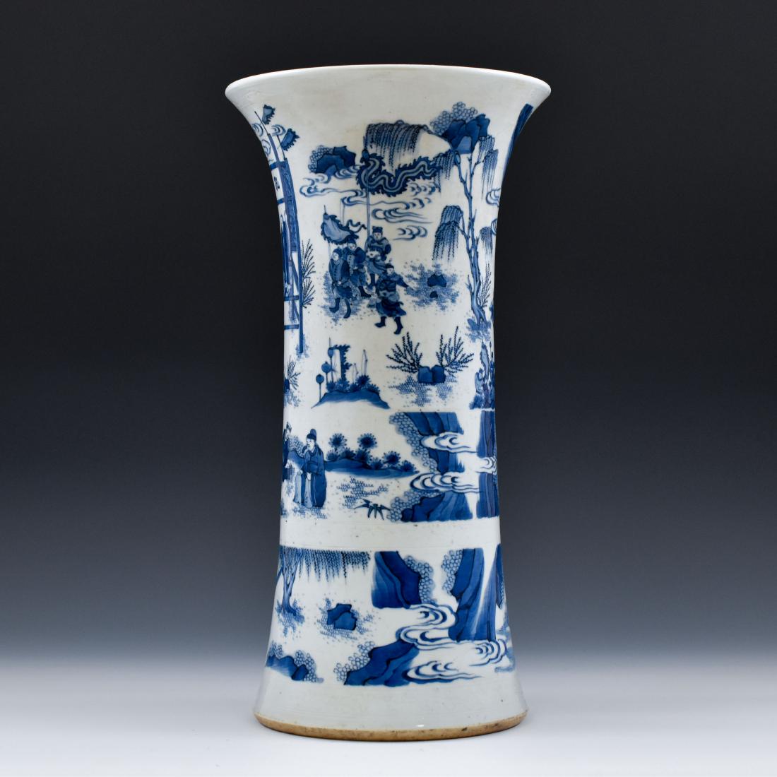 BLUE AND WHITE GU PORCELAIN VASE: The Chinese beaker vase potted in shape of a GU form, a traditional Chinese porcelain shape. The beaker potted in baluster shaped body, with bulging belly, trumpet-shaped neck are painted in variegate