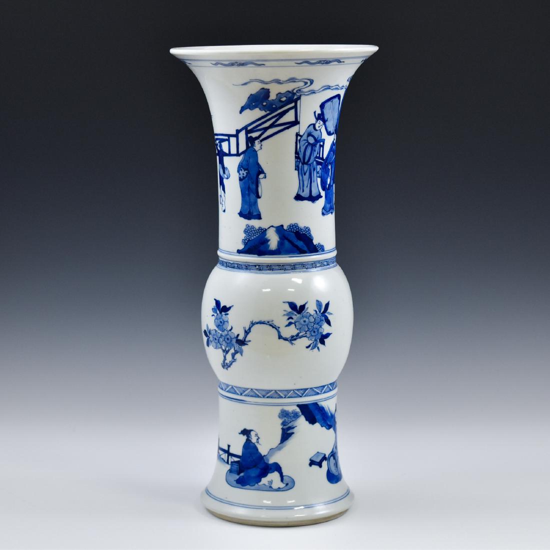 FINE CHINESE BLUE & WHITE PORCELAIN GU VASE: The vase potted in a Chinese porcelain traditional Gu shape. The beaker having baluster shaped body, with bulging belly, trumpet-shaped neck are painted in blue underglaze depicted officers and attend