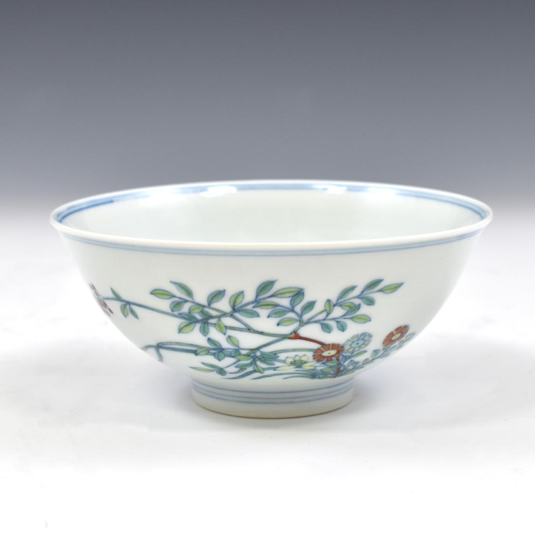YONGZHENG DOUCAI PORCELAIN BOWL: Chinese Qing Dynasty Yongzheng DouCai porcelain bowl. Deep curvature flaring upward to form the rim, with a slightly raised footing. The rim has a double blue ring around the inner and outer edge. The