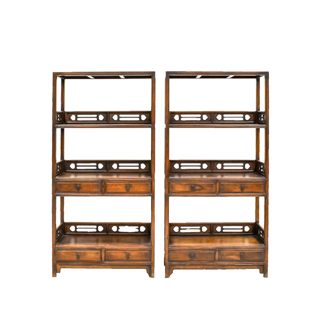 PAIR OF CHINESE HUANGHUALI BOOK SHELF CABINETS: A pair of Antique Chinese HuangHuaLi book case, with three level opened shelves. The rails decorated in relief with open-works ruyi motif. Four drawers set unto middle shelf section and lower base, wi