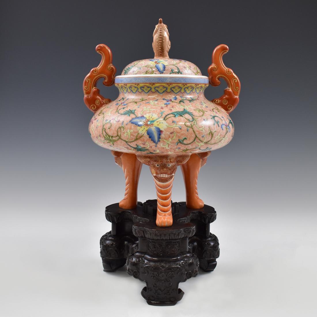 JURENTANG FAMILLE ROSE & GILT PORCELAIN CENSER ON STAND: A Chinese porcelain covered tripod censer, of compressed globular body, raised on three cabriole legs emerged from a tiger mask, two carmine-red fish dragons flanked on the lip toward the collar. The 
