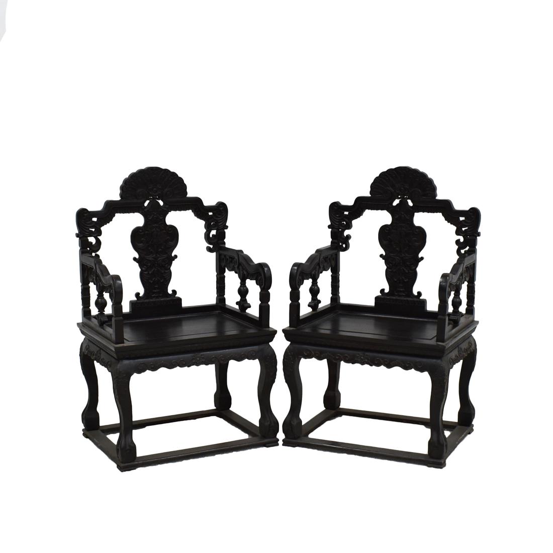 PAIR OF ANTIQUE CHINESE CARVED ZITAN MASTER CHAIRS: Pair of Antique Chinese Zitan Rococo motif Master Armchairs, the stepped back and arms, with open-work rococo floral panels, over a rectangular seat with carved floral apron, beneath floral shaped bac