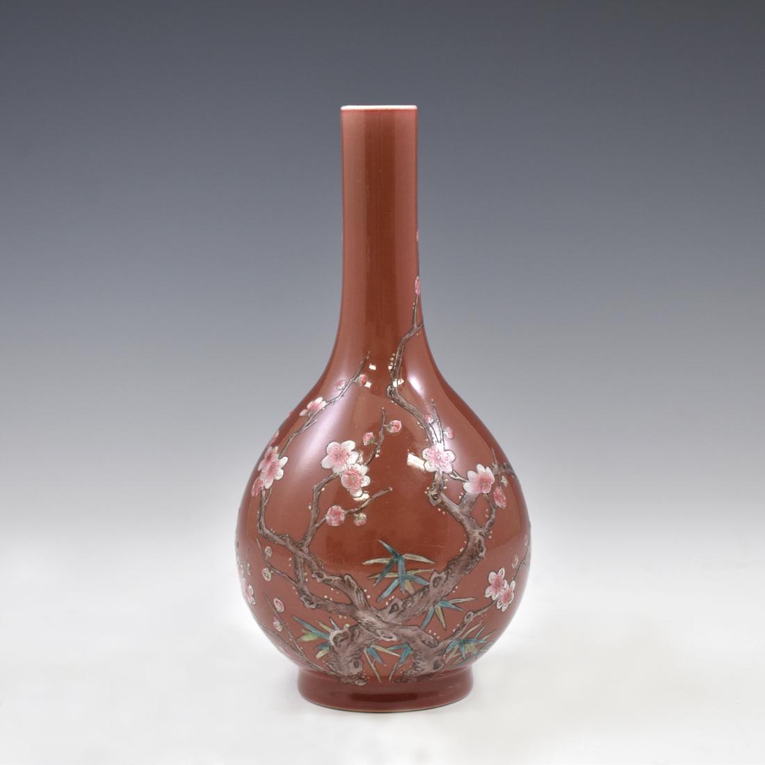 QIANLONG CHERRY BLOOM RED GROUND BILLE BOTTLE: A Chinese porcelain bile bottle vase. The immaculate porcelain body is covered with a characteristic silky glaze. Ribbed feminine body rises naturally into a straight long neck, outward at the ovoid o