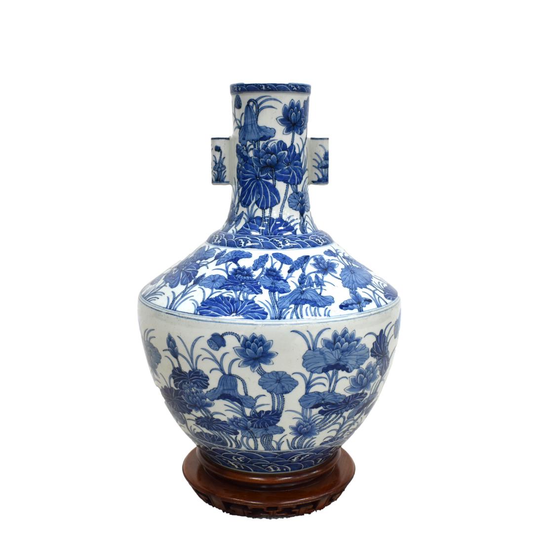 LARGE BLUE & WHITE LOTUS WRAPPED AMPHORA VASE: Large Chinese Blue and white wrapped lotus floral porcelain amphora vase. Potted with a bulbous lower body, gently tapper the faceted shoulder, with two cylindrical ears flanked on the neck, elevated