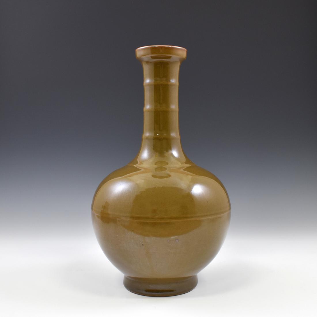 GUANGXU ZIJIN GLAZED REWARD VASE: The three molded rings banded on the neck of this smooth surface of the vase is decorated in brown glaze. The bottle neck is long and slender, with arc shaped belly of the vase. Mark on base, a vertic