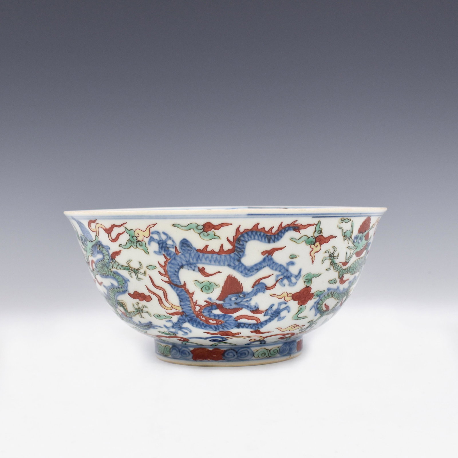 WANLI WUCAI DRAGON PORCELAIN BOWL: Dimensions: 3-5/8" H x 8-1/4" Dia. Chinese Ming Dynasty Period, Wanli Wucai Dragon porcelain bowl. The porcelain potted with a shallow body, of a shallow vessel, with flaring opening lip, raised on a 