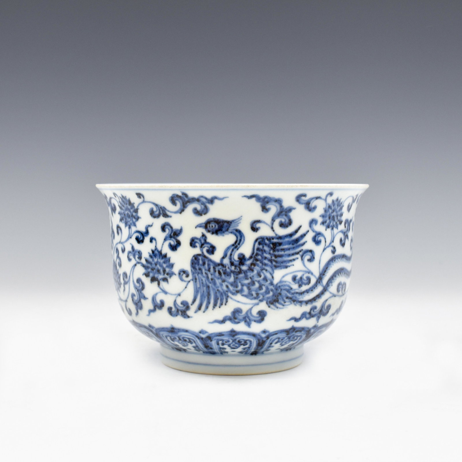 XUANDE BLUE AND WHITE BOWL: Dimensions: 3-7/8" H x 6-1/8" Dia. Chinese Ming Dynasty Period, Xuande blue and white phoenix porcelain bowl. The porcelain potted with a shallow body, of a shallow vessel, broad wide cavetto, with a 