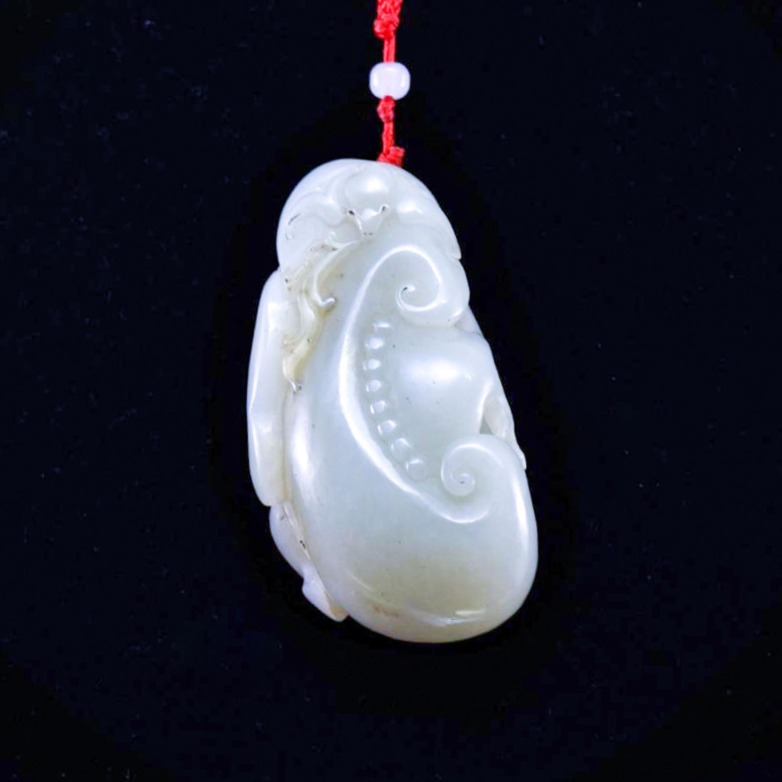 FU-BAT AND LINGZHI MUSHROOM JADE PENDANT: Dimensions: 76.47mm H x 41.51mm W Weight: 115.30 grams The Chinese nephrite jade carved unto a Fu-Bat over Lingzhi sacred fungus. The jade shows grayish crÃ¨me iridescent with moist milky appearance