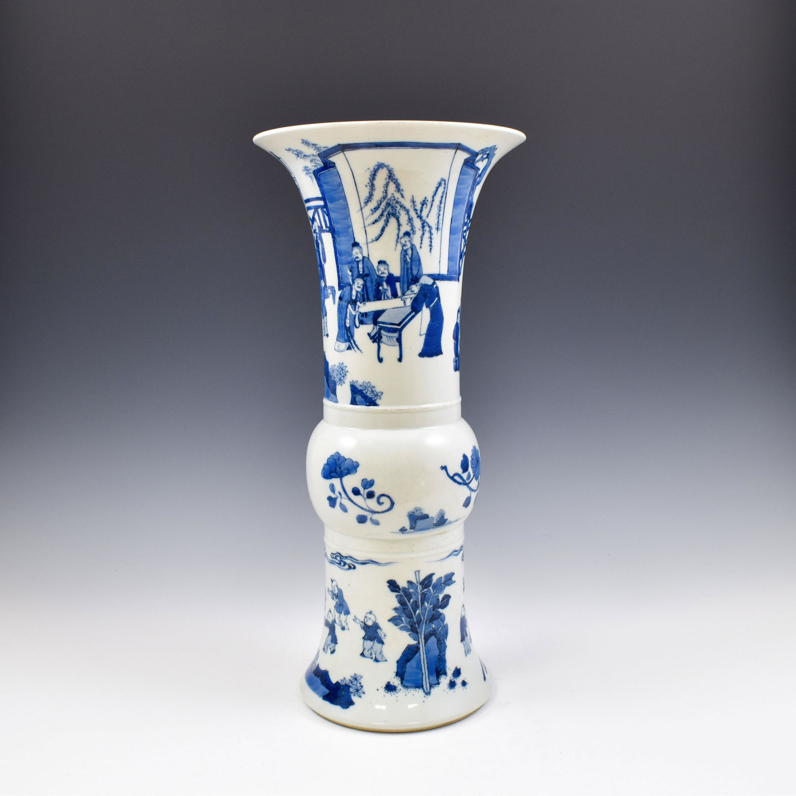 KANGXI BLUE & WHITE PORCELAIN GU VASE: Dimensions: 18-1/2" H x 8-3/8" Dia. The vase potted in a Chinese porcelain traditional Gu shape. The beaker having baluster shaped body, with bulging belly, trumpet-shaped neck are painted in blue und