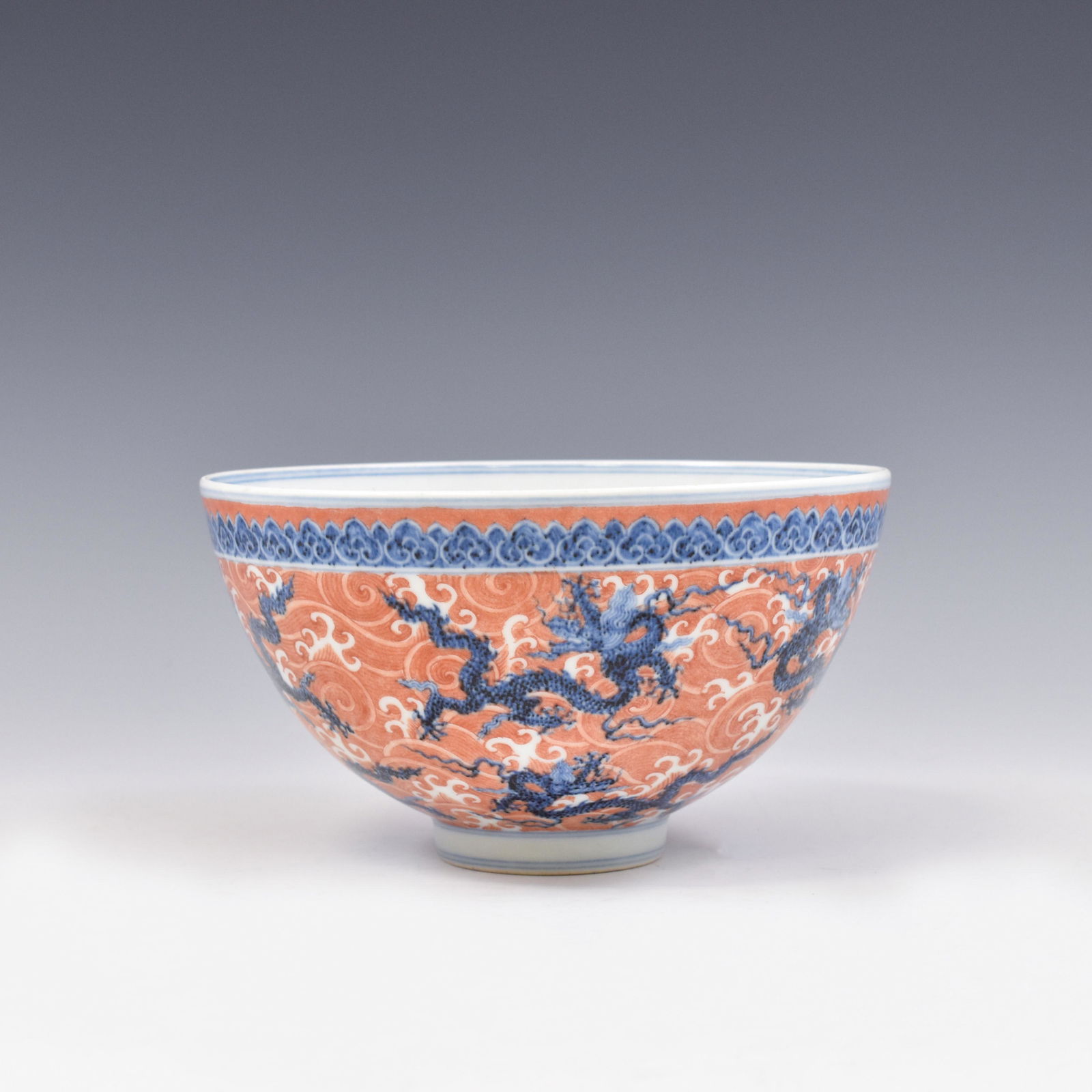 XUANDE BLUE DRAGON AND RED WAVES BOWL: Dimensions: 4-7/8" H x 4-7/8" Dia. A Superb, Chinese Ming Dynasty Xuande Reign Period, Blue and red Dragons porcelain bowl. Deep curvature, of a deep vessel, round straight upward to form the rim, wid